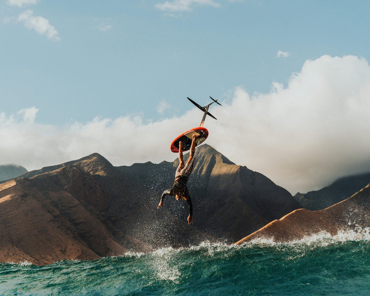 Prone surf foiling, a rider launching off a wave